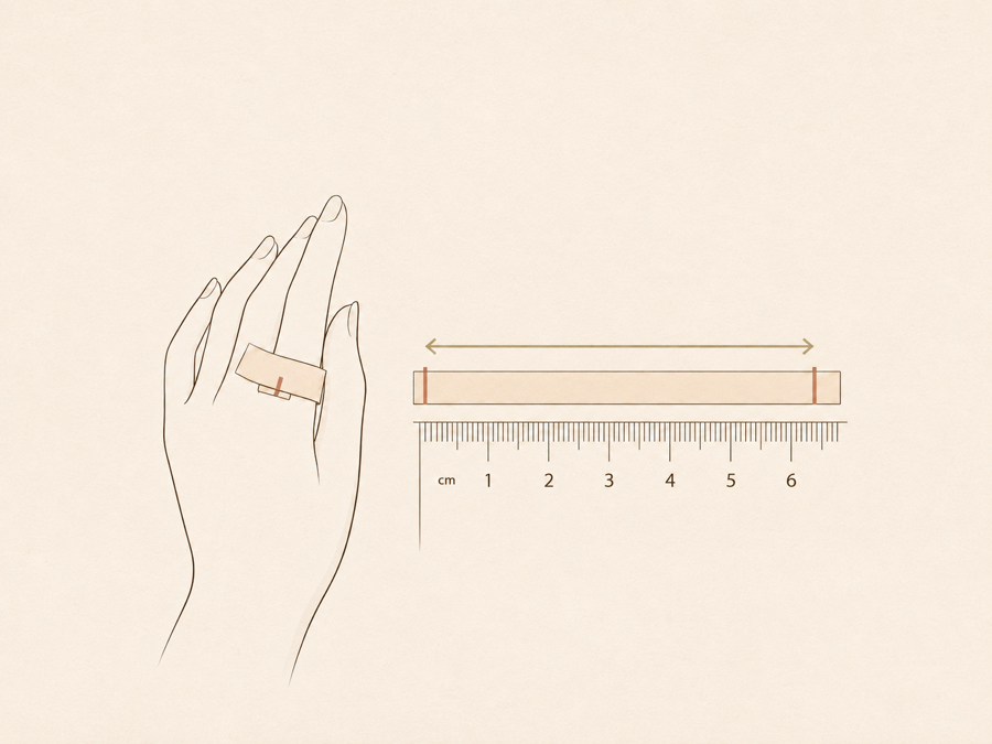 Wrapping a paper strip around a finger and measuring it on a ruler